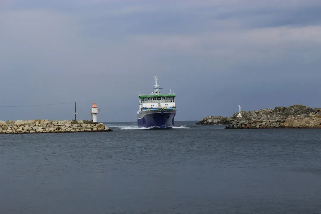 ferry arriving at a picturesque port with buildings and sea