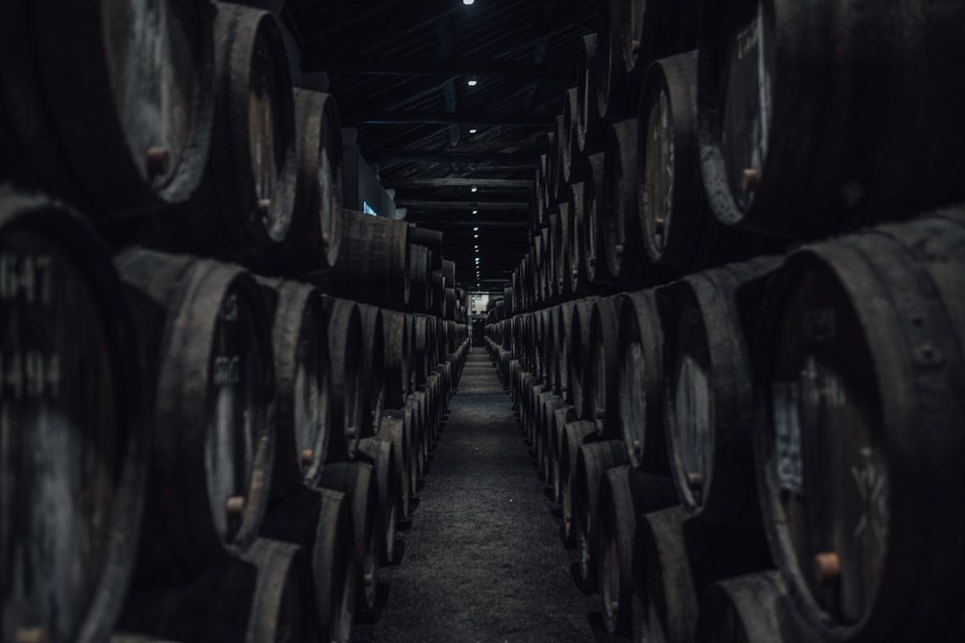 Rows of port wine barrels ageing in a cellar in Vila Nova de Gaia