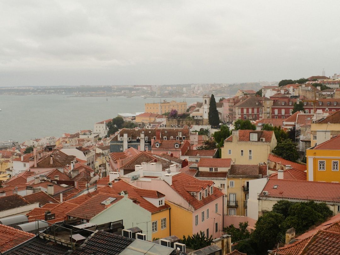 View over Alfama's terracotta rooftops towards the Tagus river in Lisbon