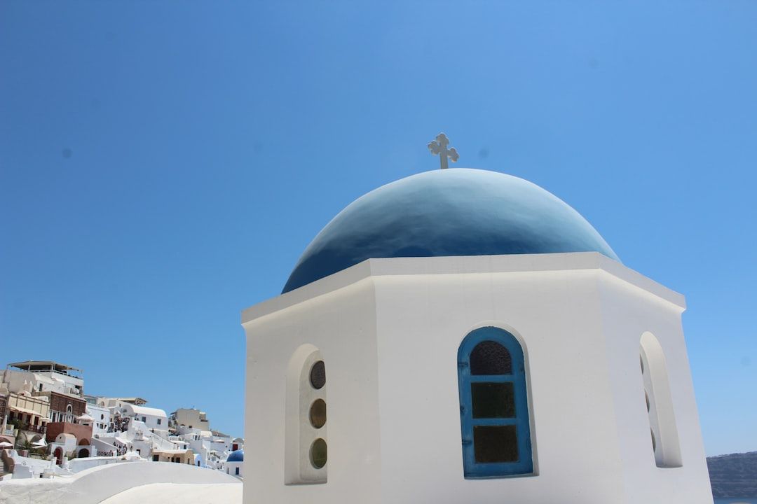 Blue-domed churches and white lanes in Oia, Santorini, early in the morning