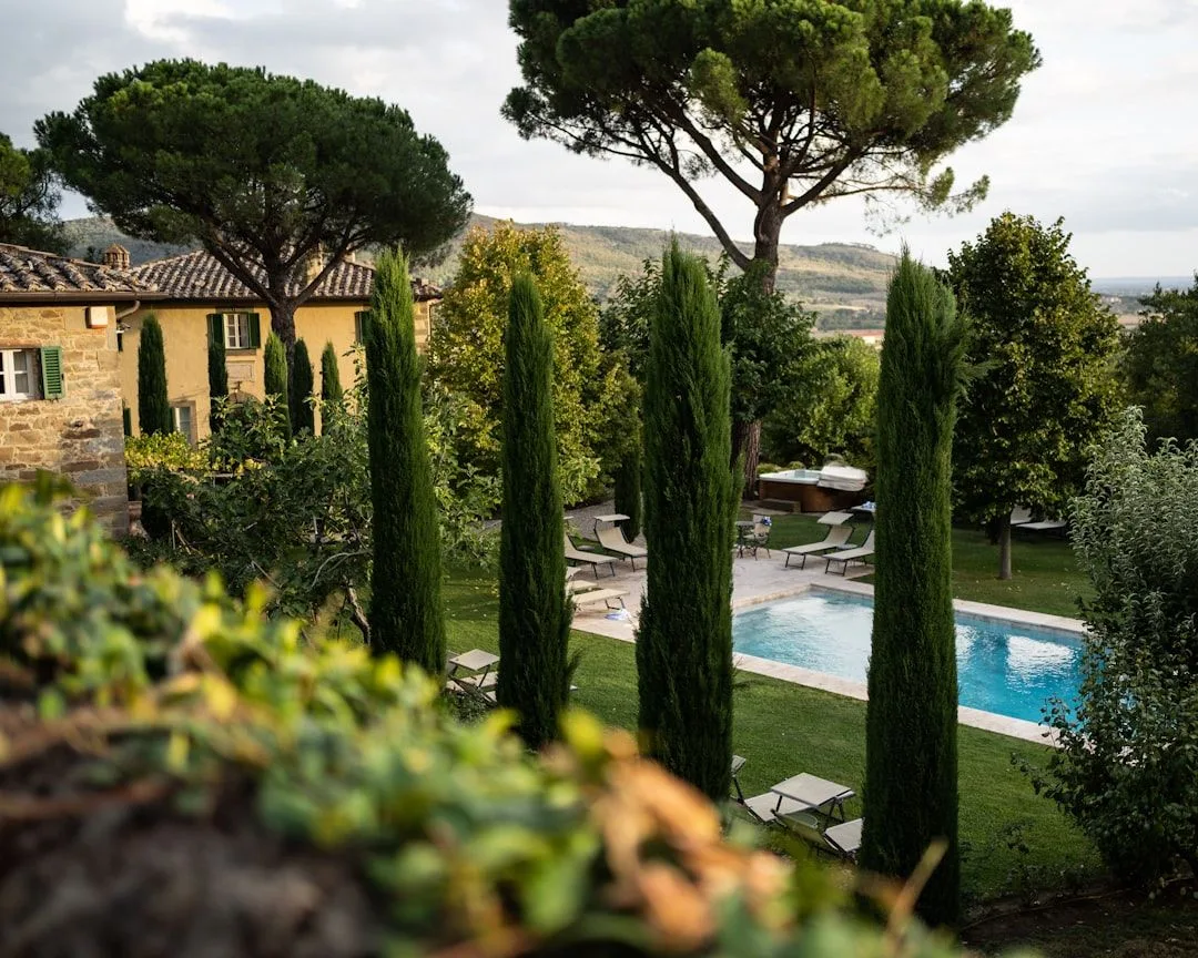 A Tuscan agriturismo farmhouse with a swimming pool overlooking vineyards